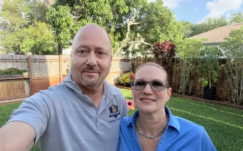Glen and Michelle of Defender Inspections in a South Florida backyard